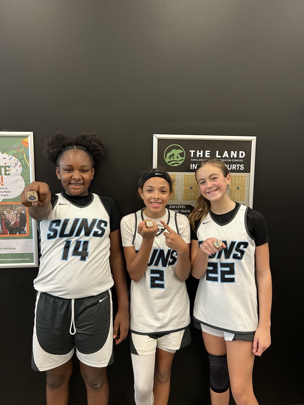 850 Suns players showing their championship rings