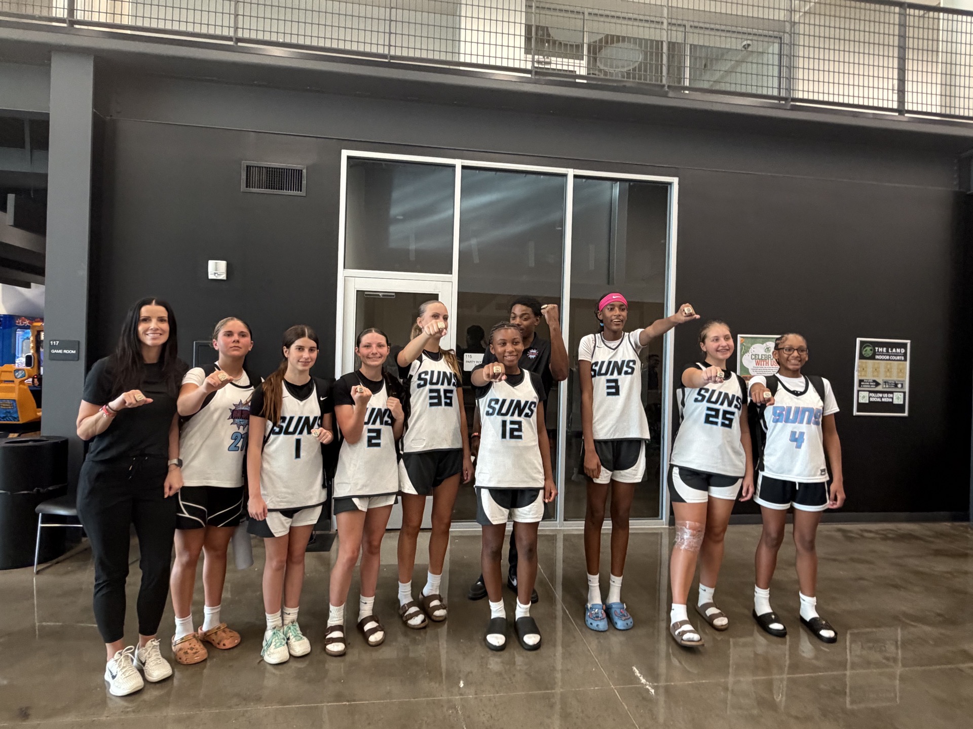 850 Suns girls basketball team celebrating together